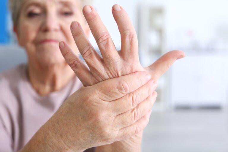 Woman holding her hand, it has inflammation