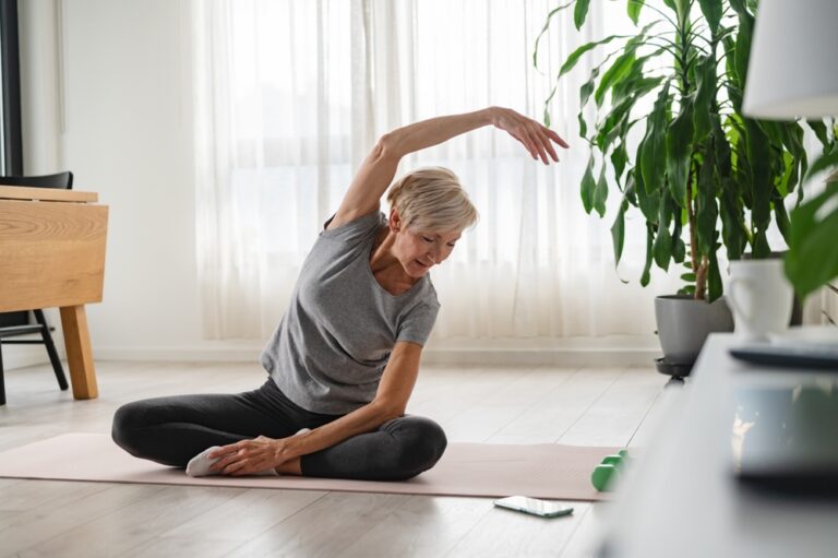 Active,Senior,Woman,Stretching,And,Exercising,Indoors.,Exercise,For,Older