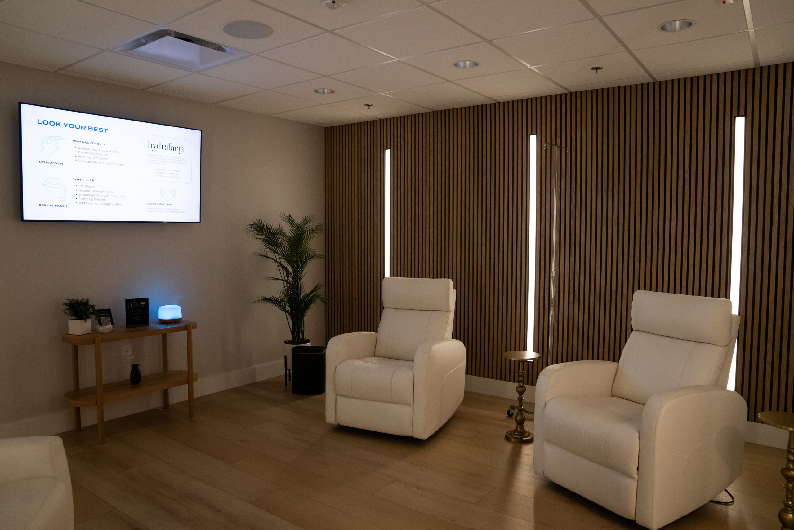 A luxurious medical clinic lounge area with plush white recliners, designed for comfortable stem cell injections at Relive Brentwood.